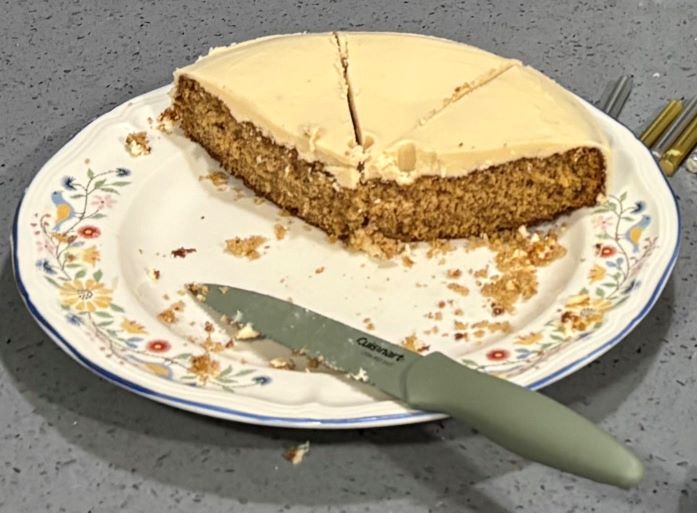 a half eaten spice cake with frosting